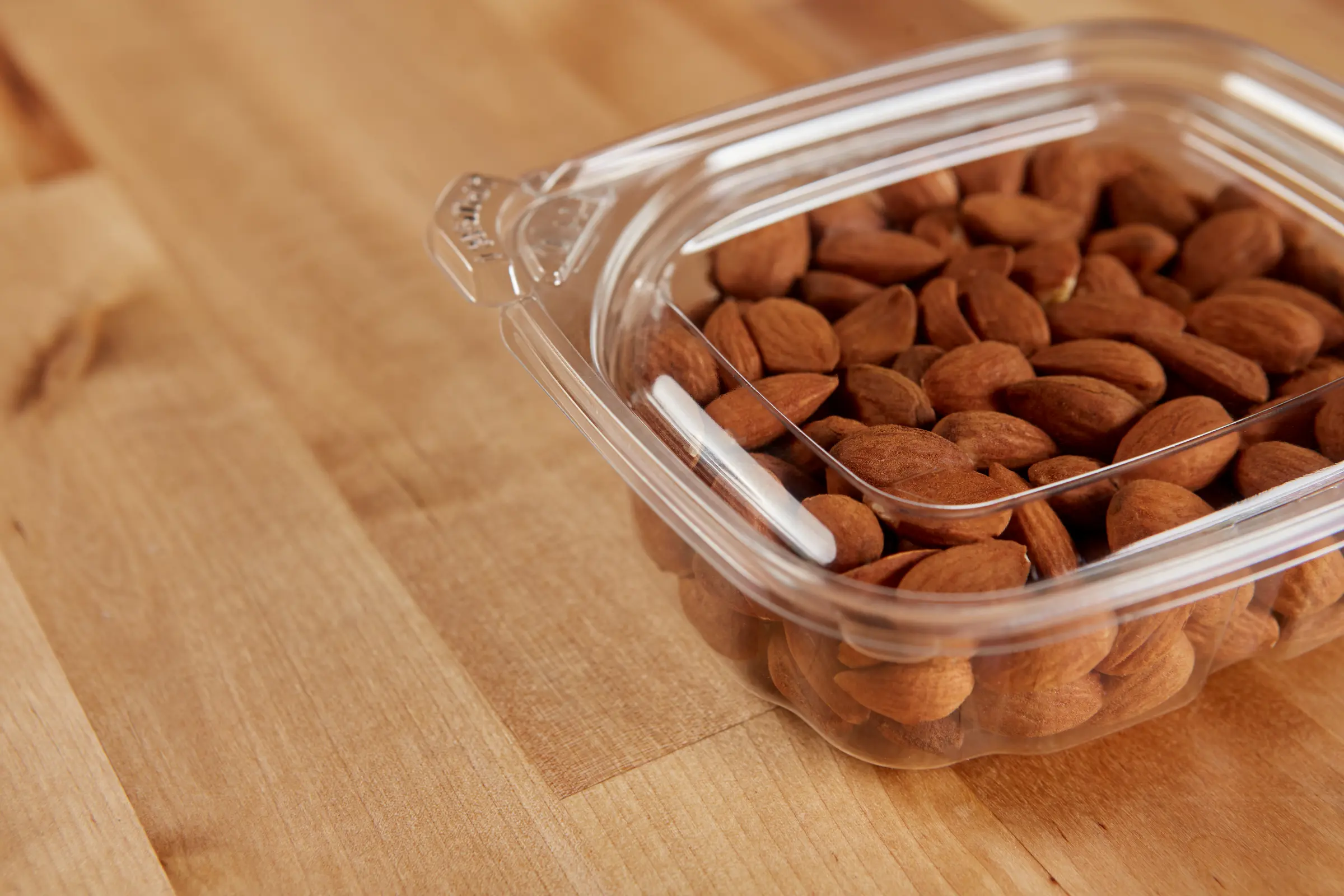 Almonds in plastic container